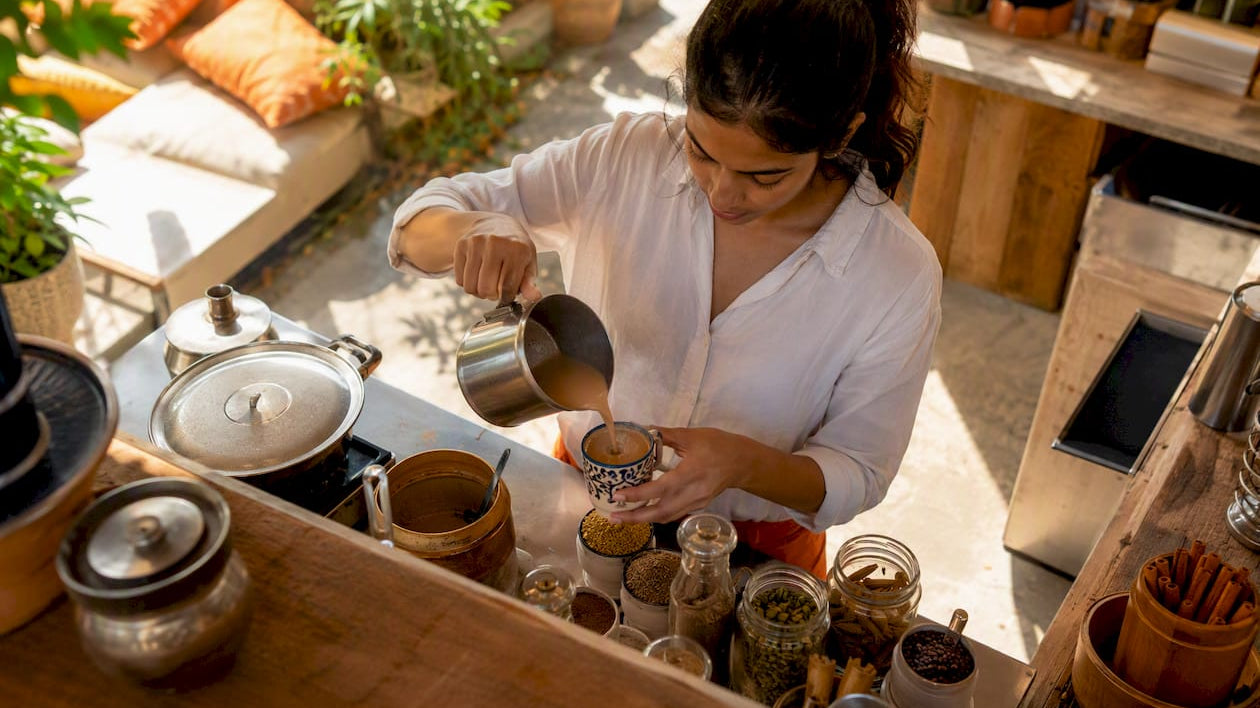 Barista preparing chai at Dropout Chaiwala cafe