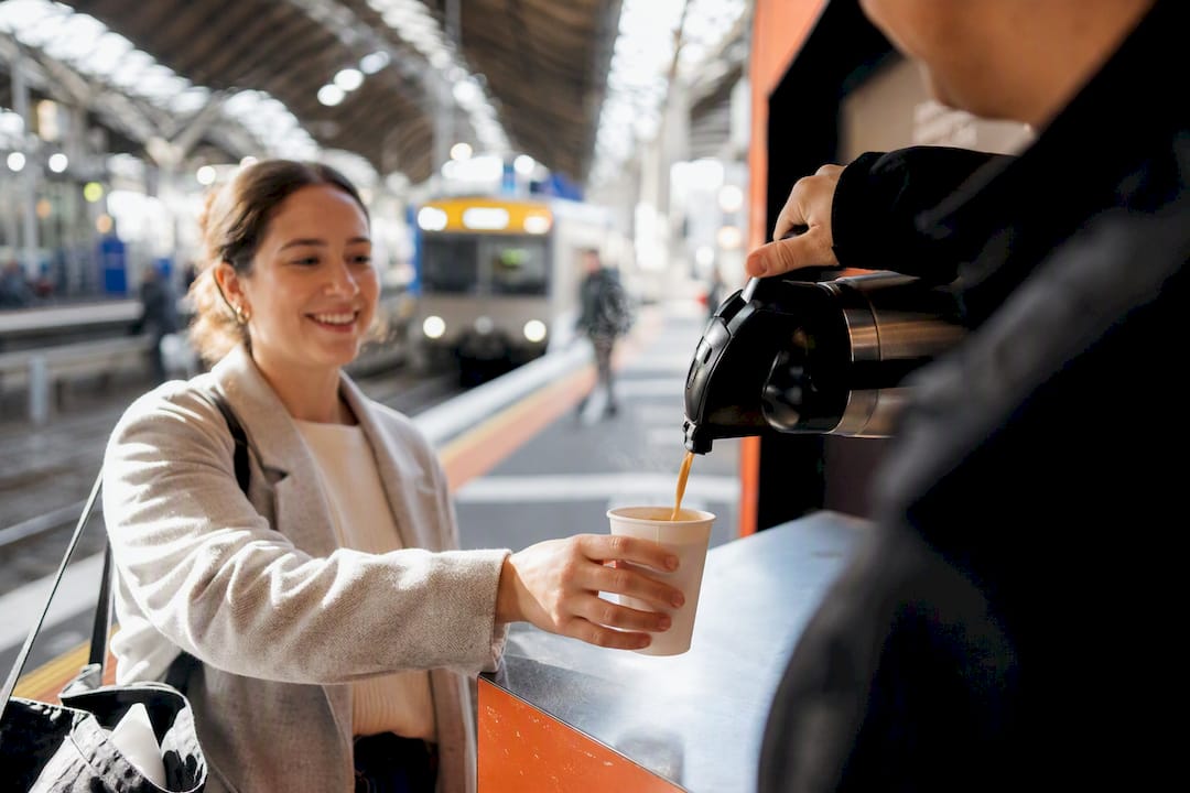 Commuter receiving chai at station counter